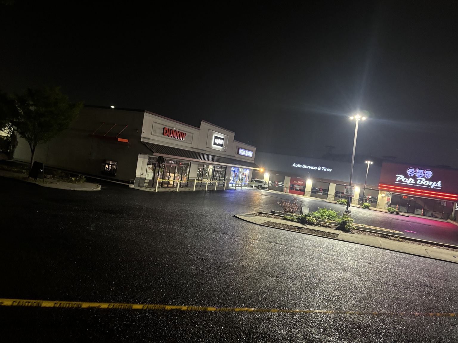 Freshly sealcoated shopping center parking lot at night