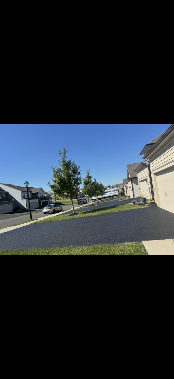 Freshly sealcoated driveway in a neighborhood of homes